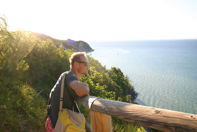 Man looking at sea against clear sky