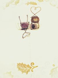 Close-up of gold colored pencils over white background