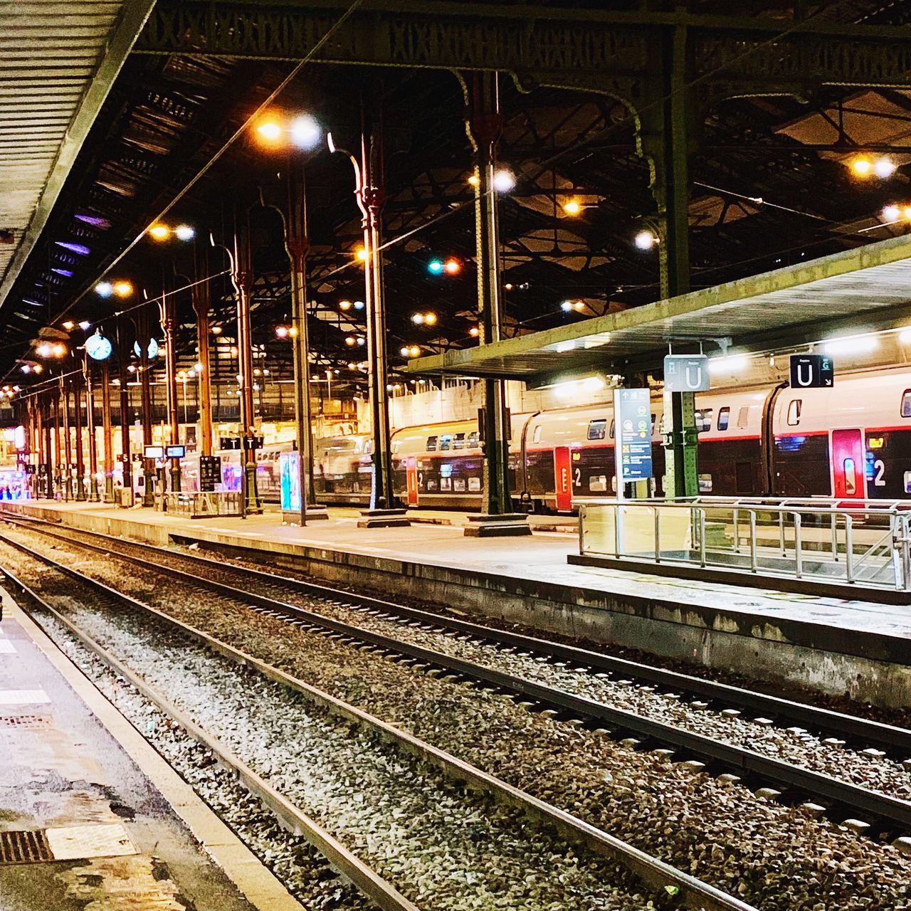 VIEW OF RAILROAD STATION PLATFORM AT NIGHT