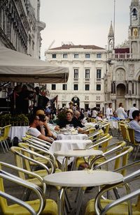 People sitting on chair in city