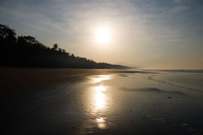 Scenic view of beach against sky during sunset