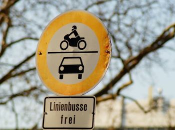 Close-up of road sign against trees