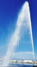 Low angle view of vapor trails in blue sky