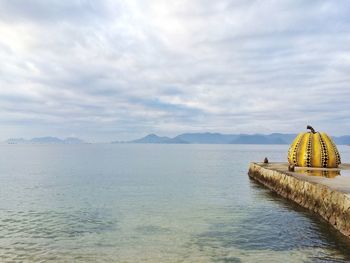 Scenic view of sea against cloudy sky