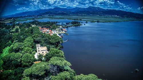 Scenic view of castle on lake shores with mountains in the background 