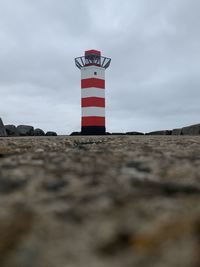 Lighthouse on building against sky