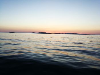 Scenic view of sea against clear sky during sunset