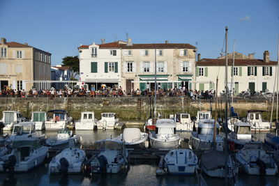 Boats moored in canal against buildings