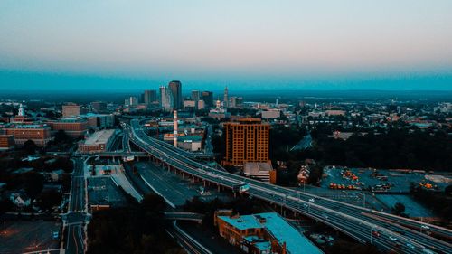 High angle view of city buildings against clear sky