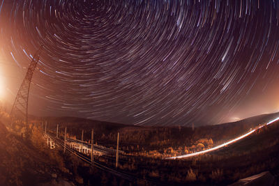 Scenic view of mountains against sky at night