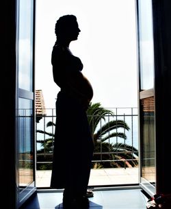 Woman standing by window