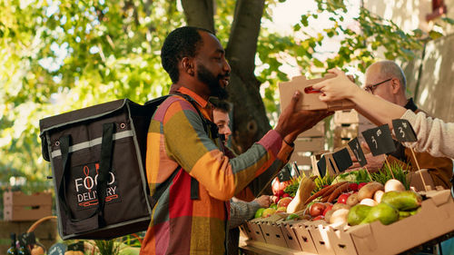 Side view of man picking apples