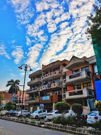 Street by buildings against sky