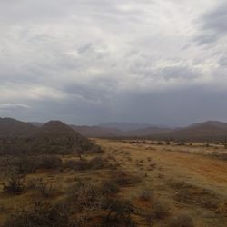 Scenic view of mountains against cloudy sky