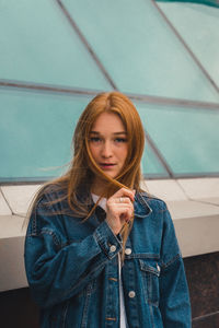 Portrait of beautiful young woman holding camera