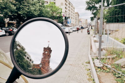 Reflection of street in side-view mirror