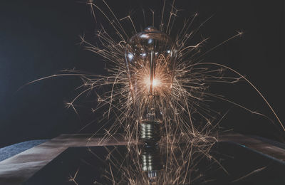 Low angle view of firework display at night