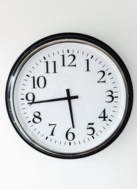 Close-up of clock on white background