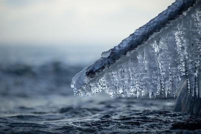 Close-up of frozen sea against sky