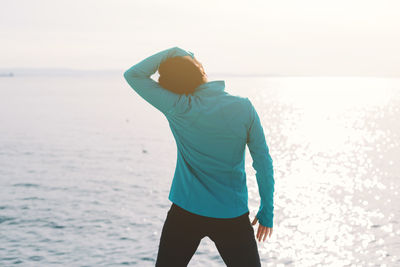 Rear view of man standing on beach