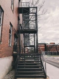 Low angle view of staircase in building against sky