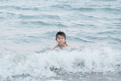 Cute girl swimming in sea