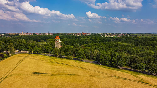 Scenic view of trees and buildings against sky