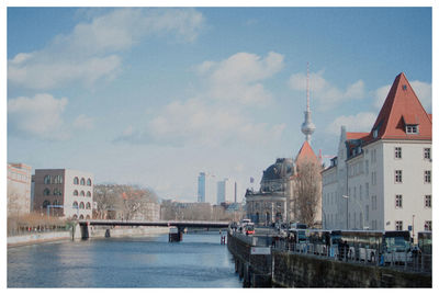 Bridge over river with city in background