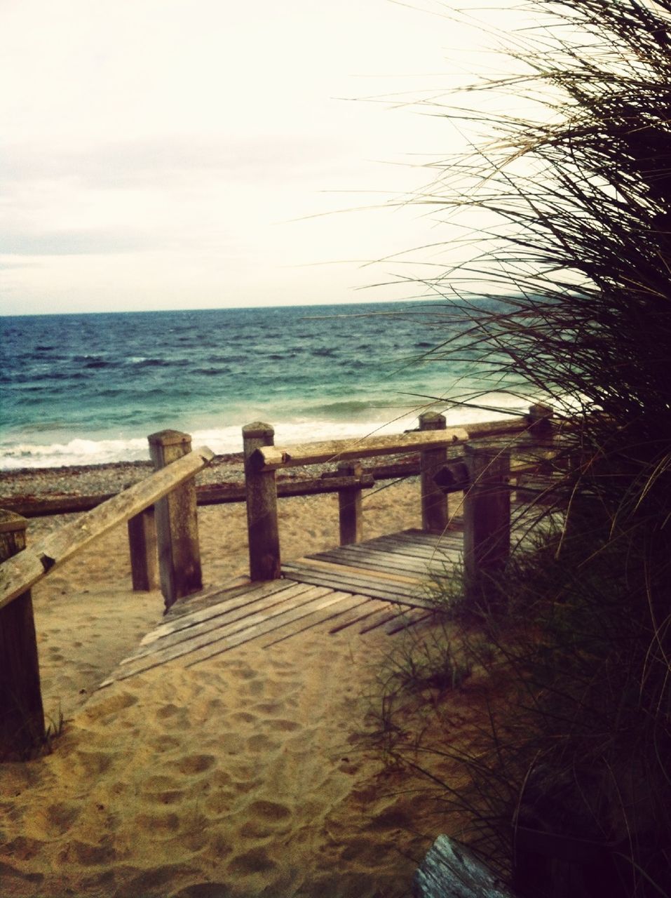 water, sea, beach, tranquility, tranquil scene, horizon over water, pier, scenics, shore, nature, wood - material, beauty in nature, sky, sand, idyllic, day, calm, jetty, outdoors, sunlight