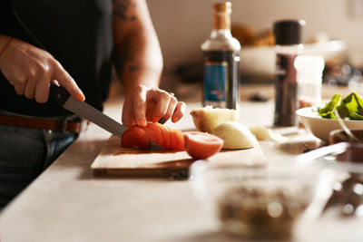 Midsection of man preparing food on table