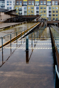 Bridge over canal in city during winter