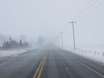 Road in foggy weather against sky