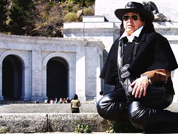 Man wearing sunglasses sitting outdoors