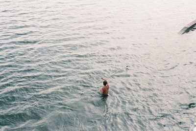 High angle view of man swimming in sea