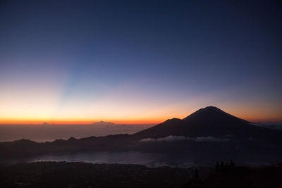 Scenic view of silhouette mountains against sky at sunset