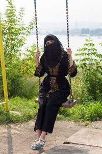 Rear view of woman standing in park