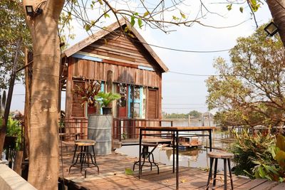 Empty chairs and tables against building