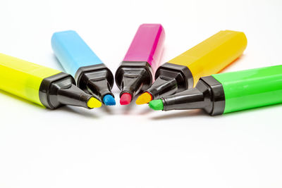 Close-up of multi colored pencils on white background