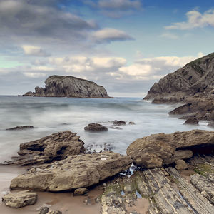 Rocks on beach against sky