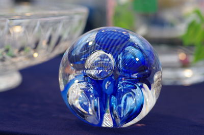 Close-up of blue crystal ball on table