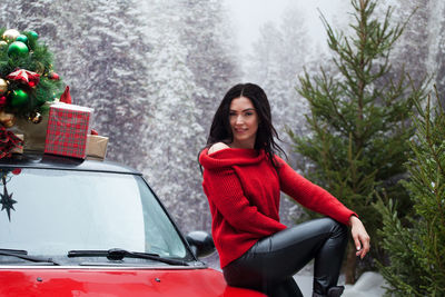 Portrait of smiling young woman in car