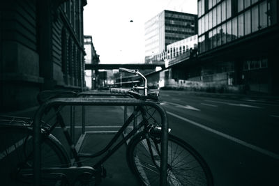 Bicycle on road by buildings in city