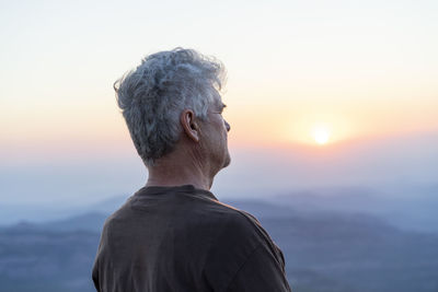Spain, catalonia, man looking at sunset in the mountains