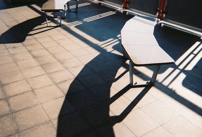 High angle view of empty chair on tiled floor