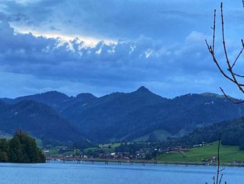 Scenic view of lake and mountains against sky