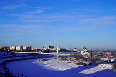 Scenic view of river against blue sky during winter