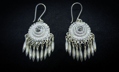 Close-up of ornate decoration against black background