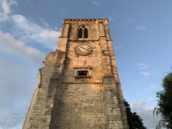 Low angle view of clock tower against sky