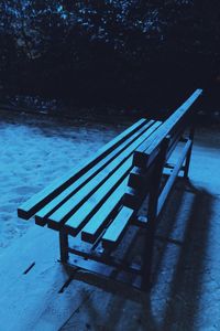 Empty bench in water
