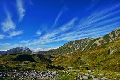 Scenic view of mountains against blue sky